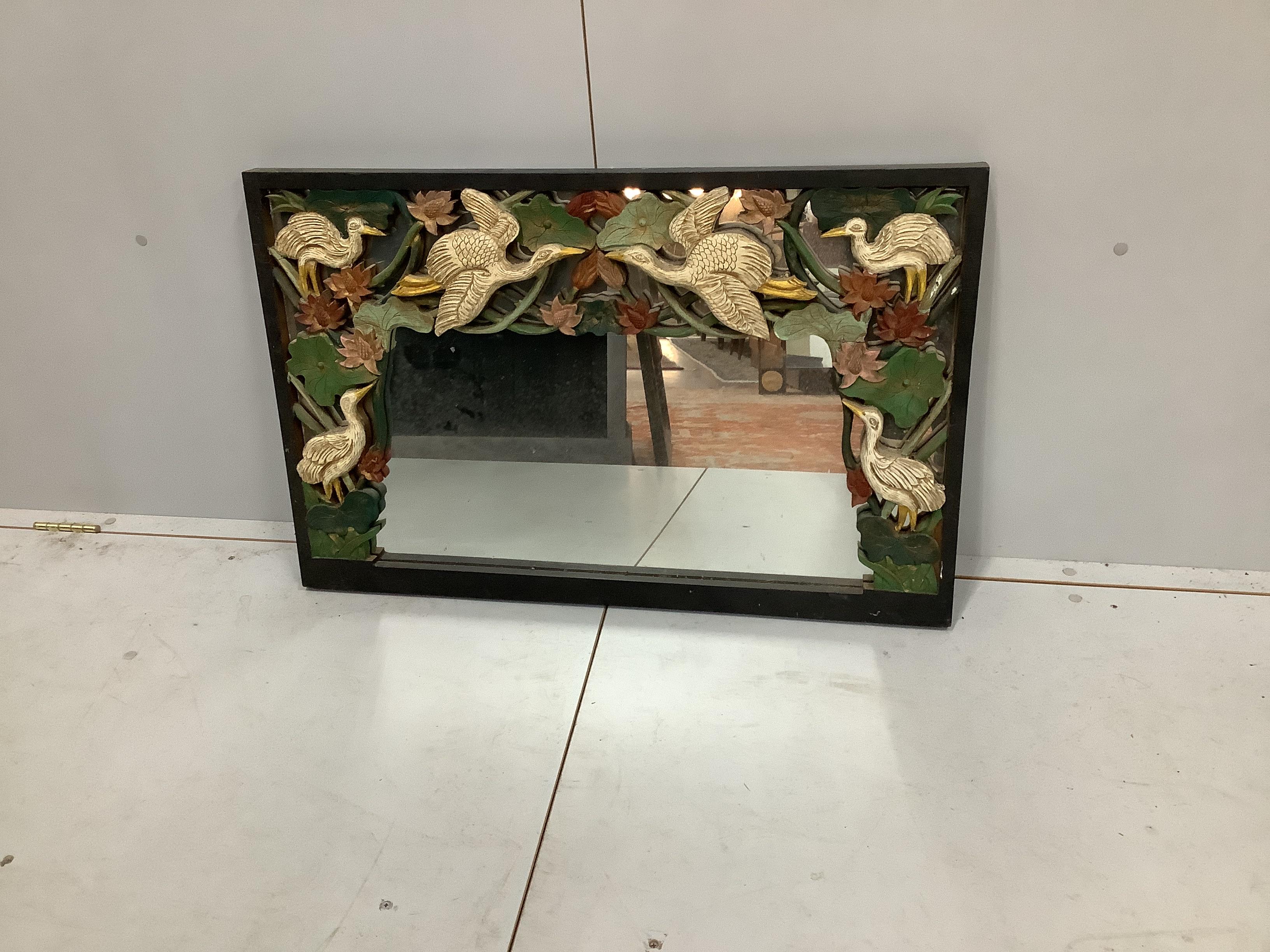 An Indian painted carved hardwood wall mirror, width 88cm, height 58cm